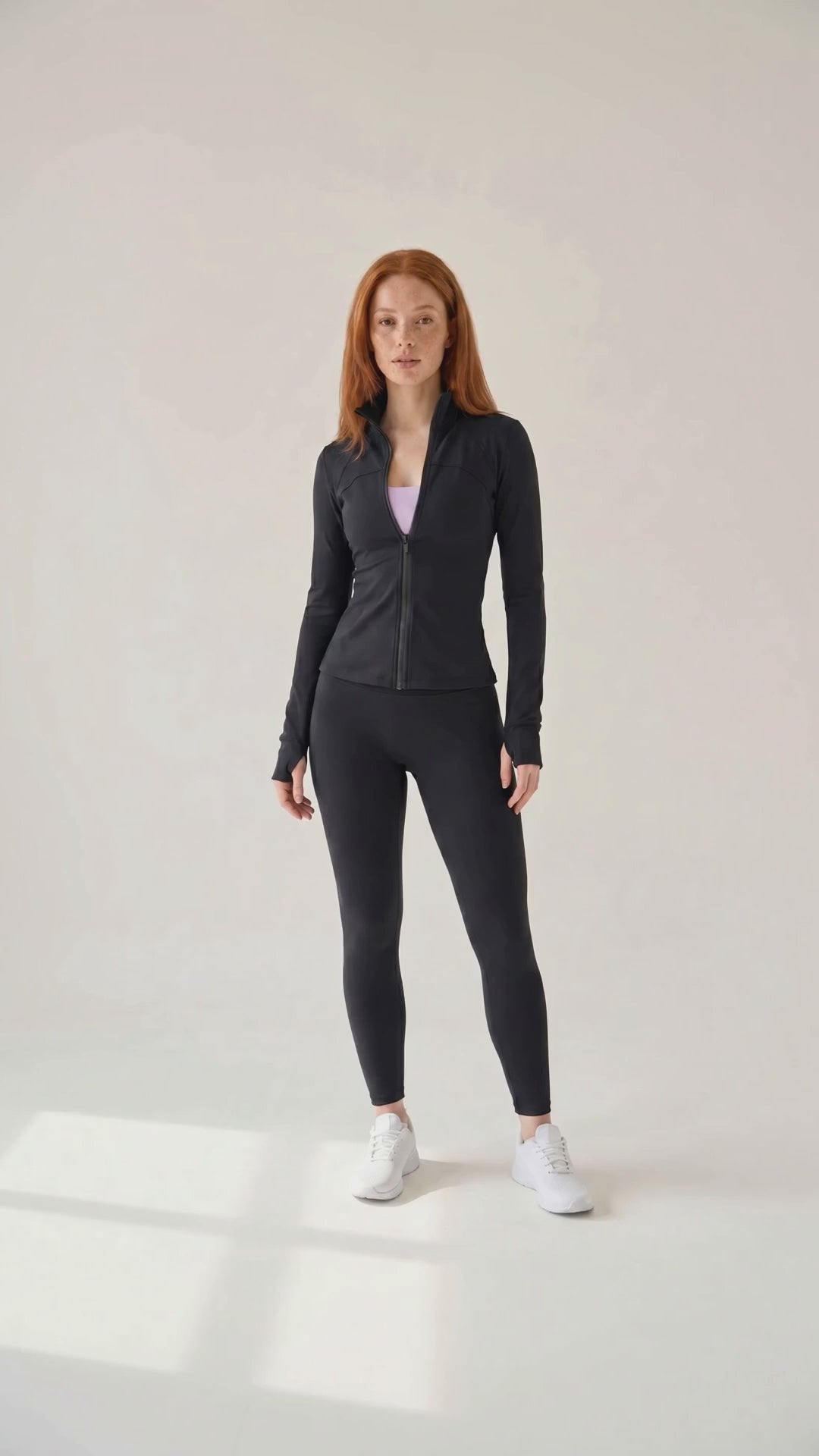 Athletic Zip Jacket — on model video, walks toward camera, black